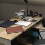 A wooden desk topped with a laptop computer